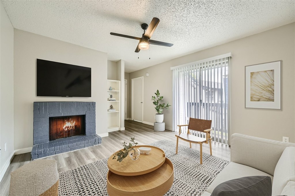 A living room with a fireplace and a television.