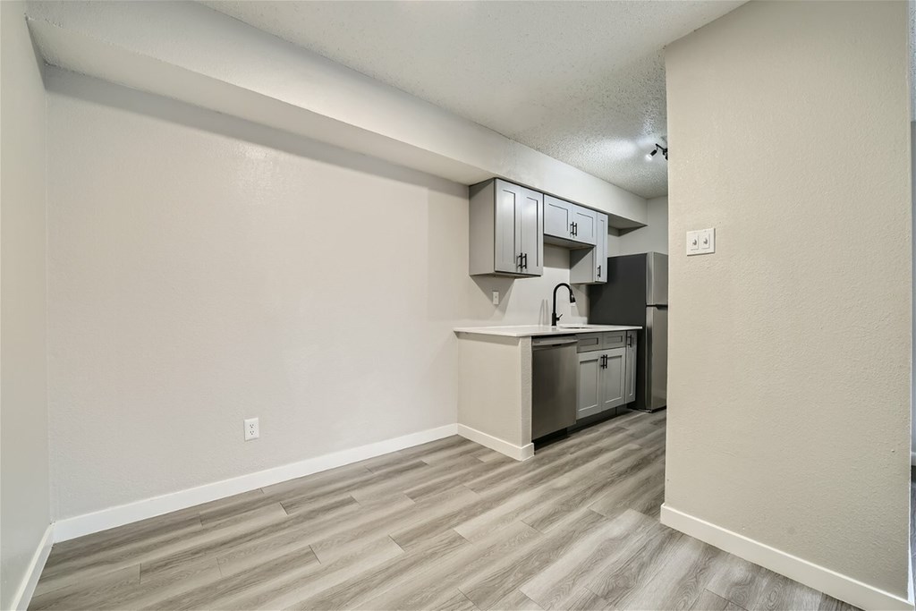 A kitchen area with a counter and cabinets.