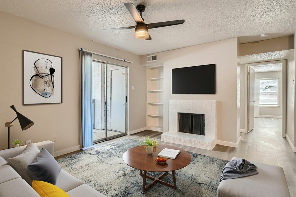 A living room with a fireplace and a television.