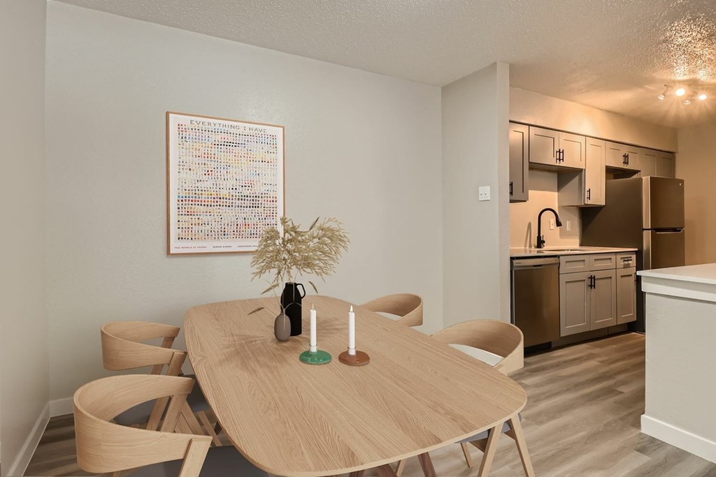 A dining area with a wooden table and chairs.