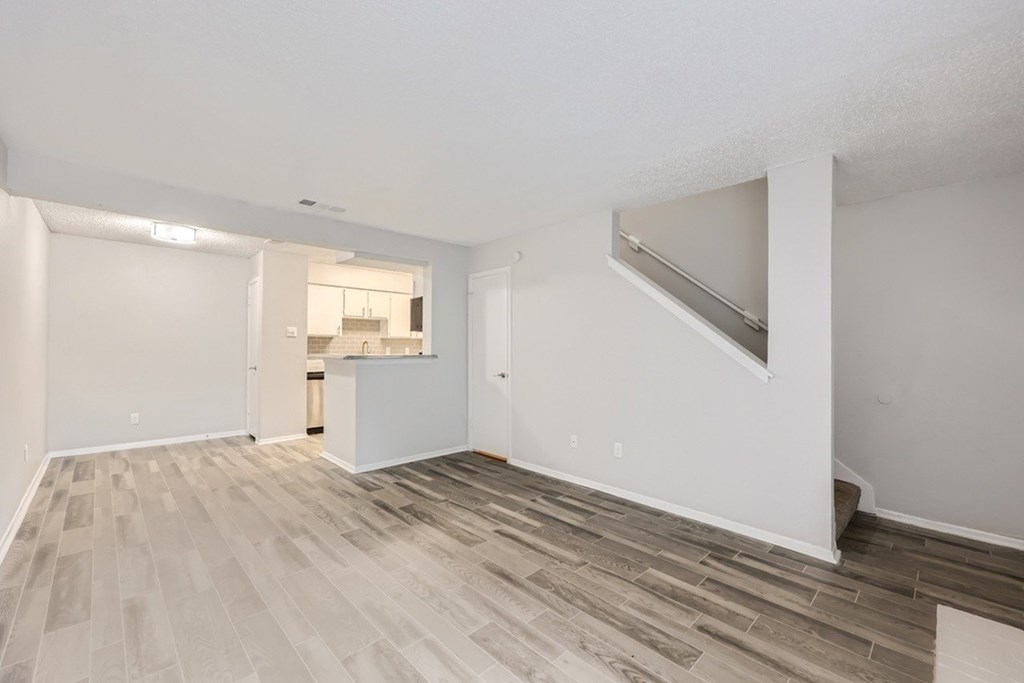 A room with a white ceiling and a wooden floor.
