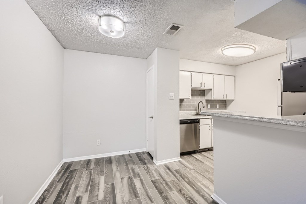 A kitchen area with a dishwasher and cabinets.
