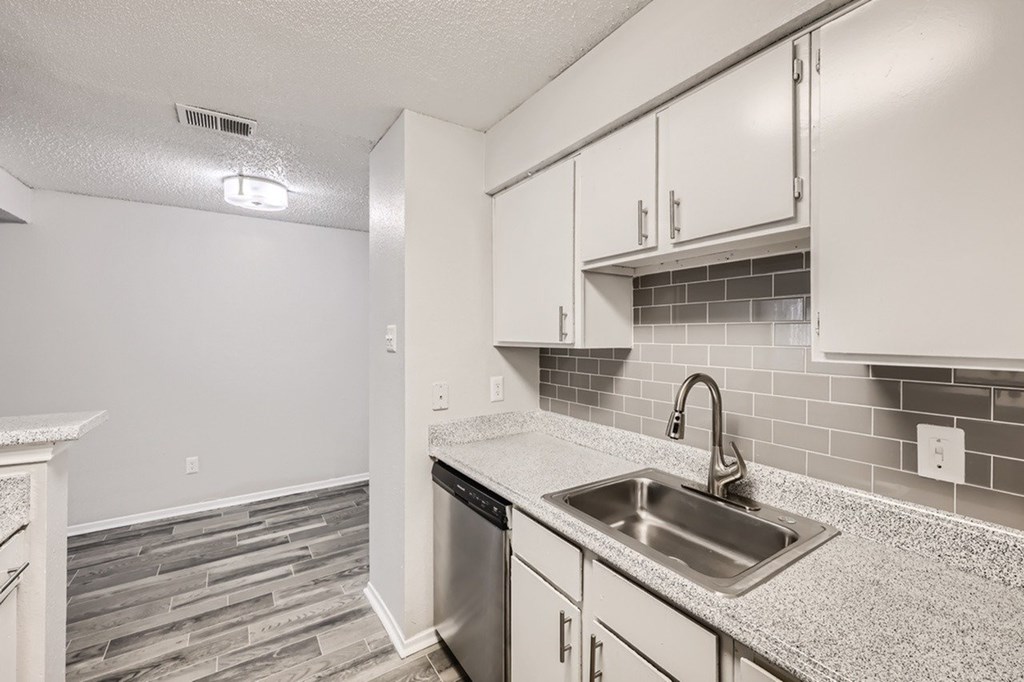 A kitchen with a sink and a dishwasher.