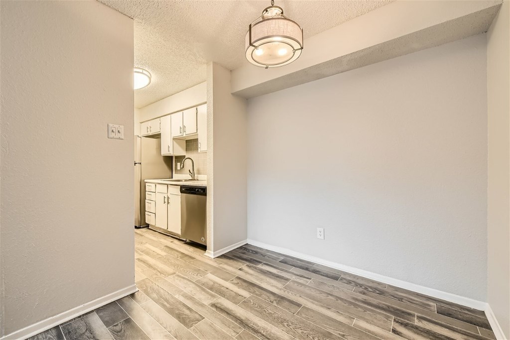 A kitchen area with a dishwasher and cabinets.
