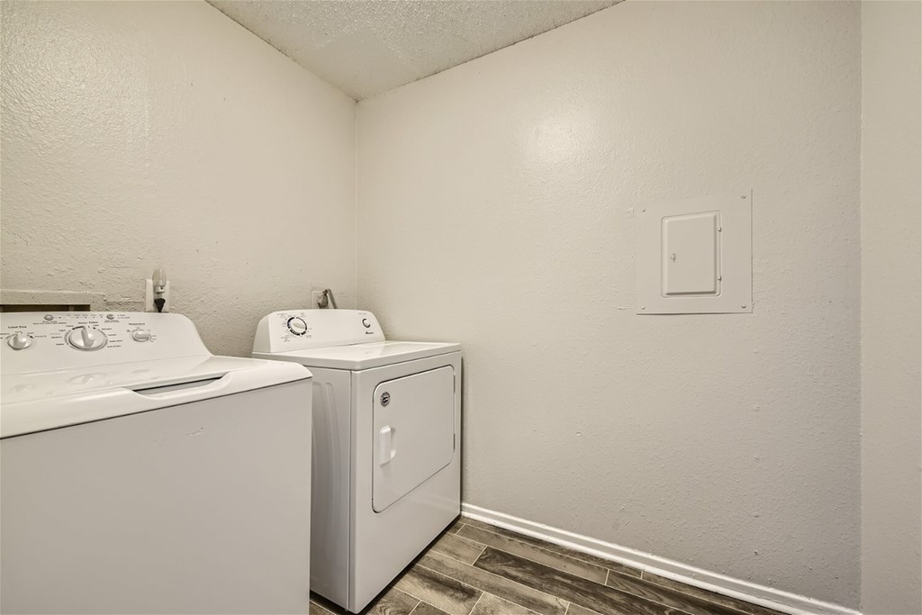 A white washing machine and dryer in a small laundry room.