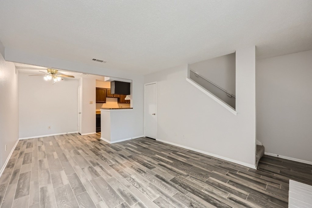 A room with a grey tiled floor and white walls.