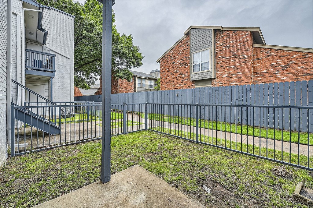 A kitchen with brown cabinets and a white refrigerator.