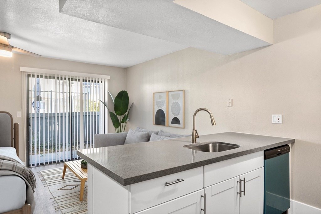 A modern kitchen with a large island and a sink.
