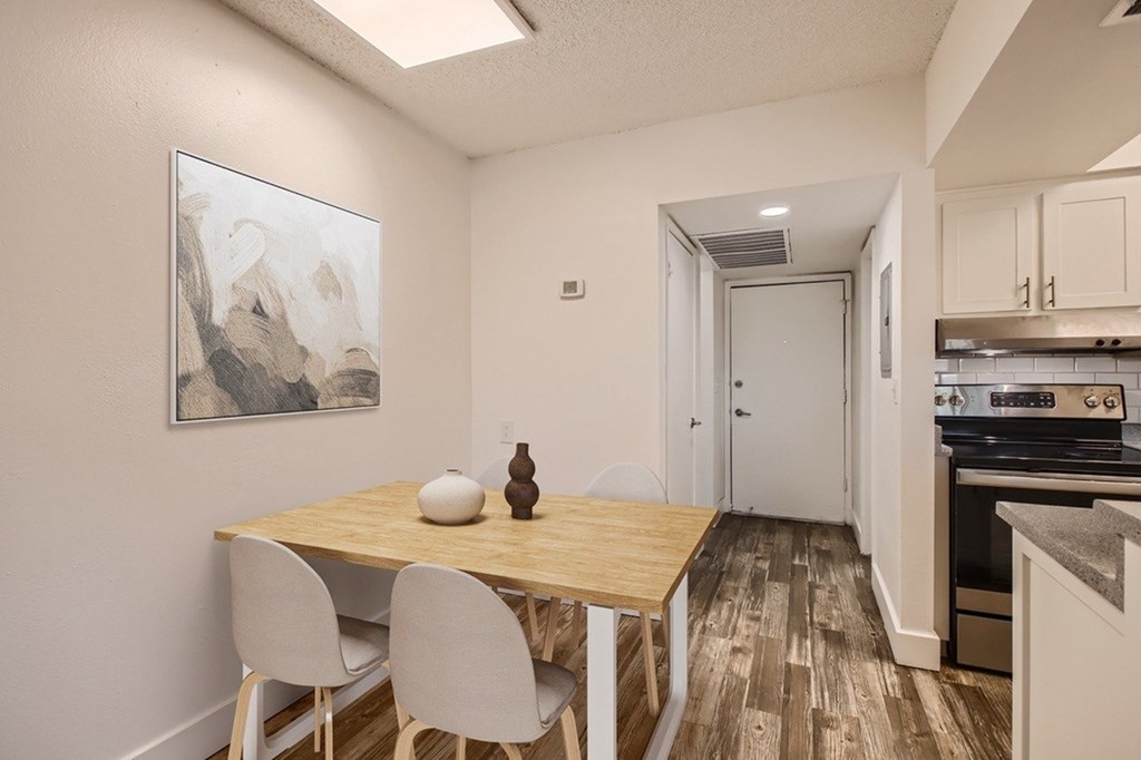 A dining area with a wooden table and chairs.