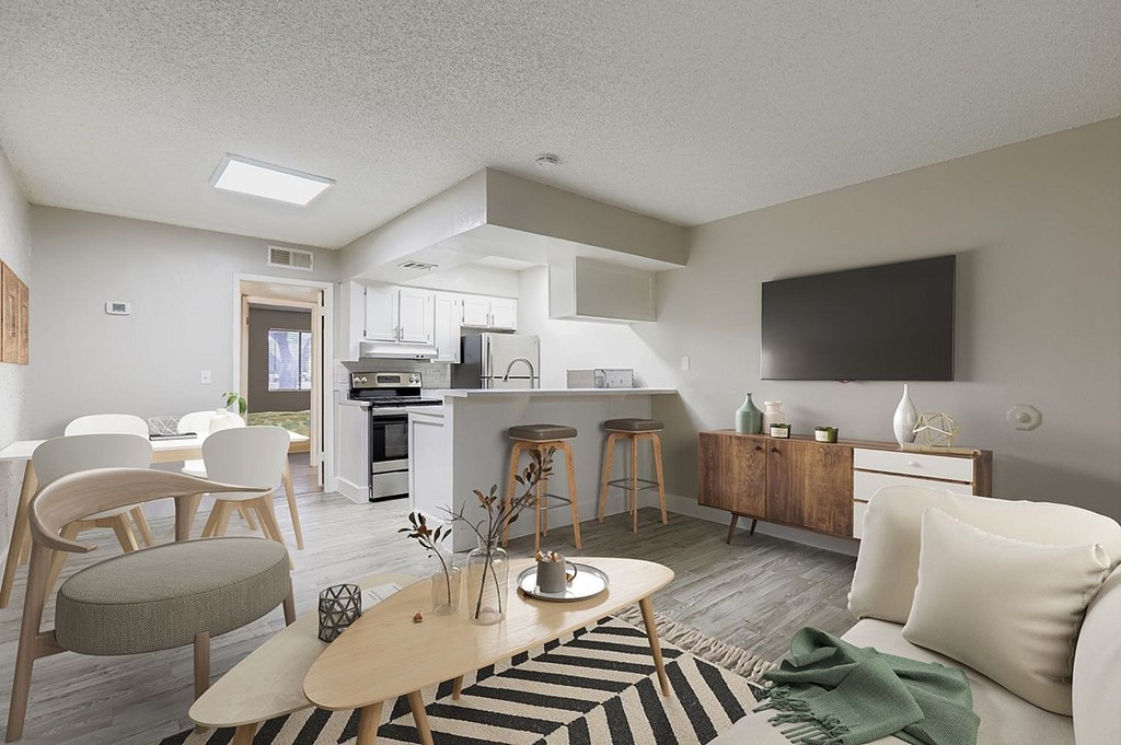 A kitchen area with a white cabinet and a microwave on top.
