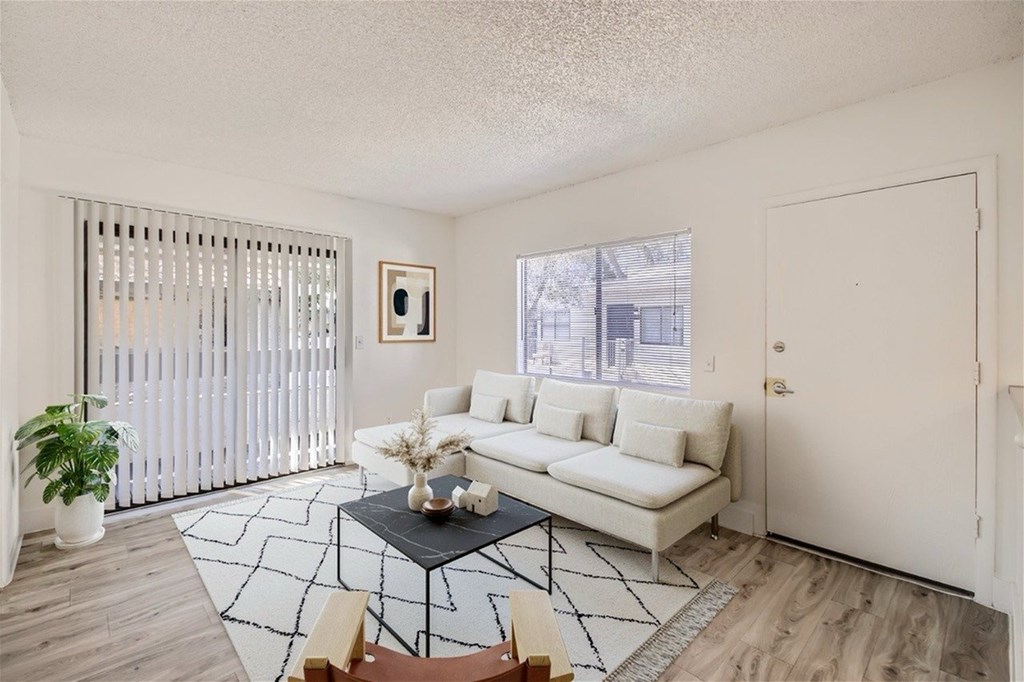 A living room with a white couch and a coffee table.