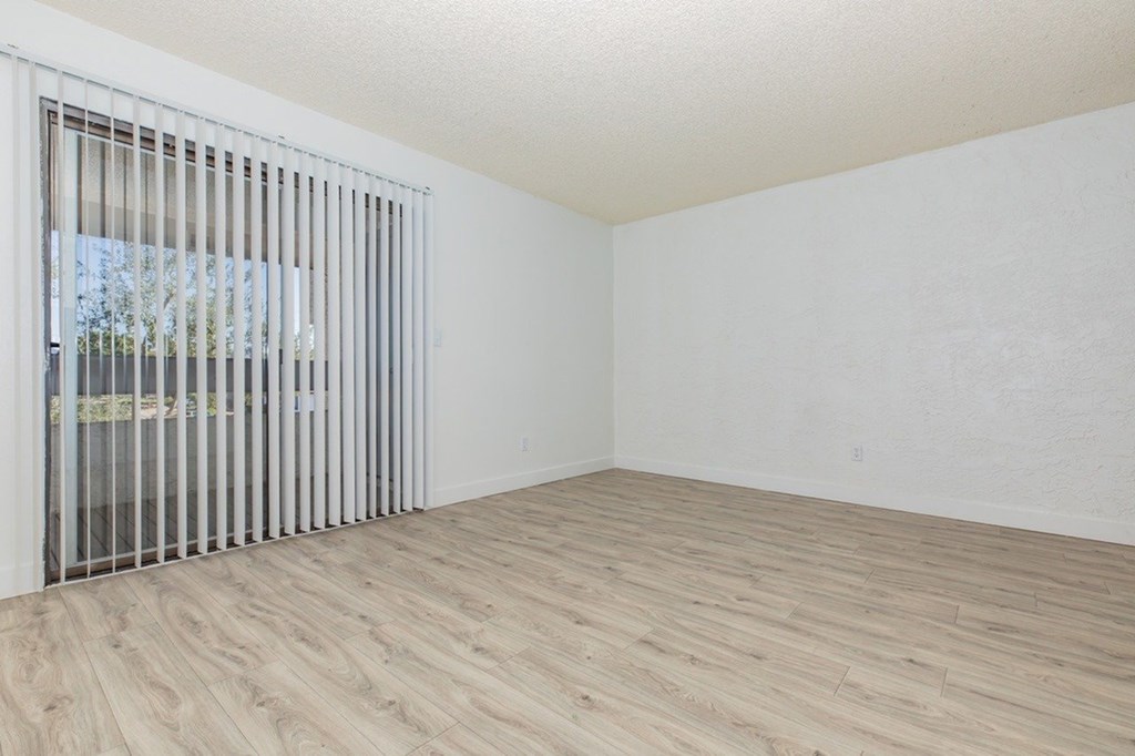 A room with a sliding door and wooden flooring.