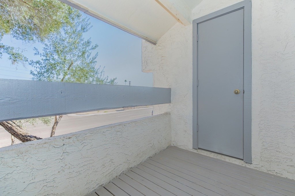 A grey door is closed and has a brass handle.