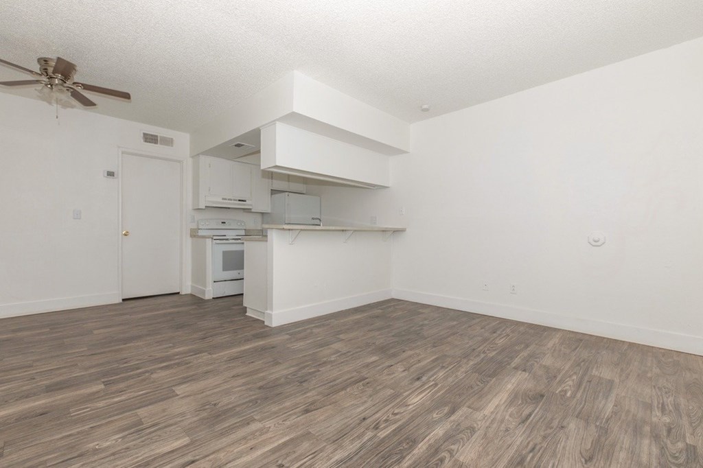 A kitchen with a ceiling fan and a countertop.