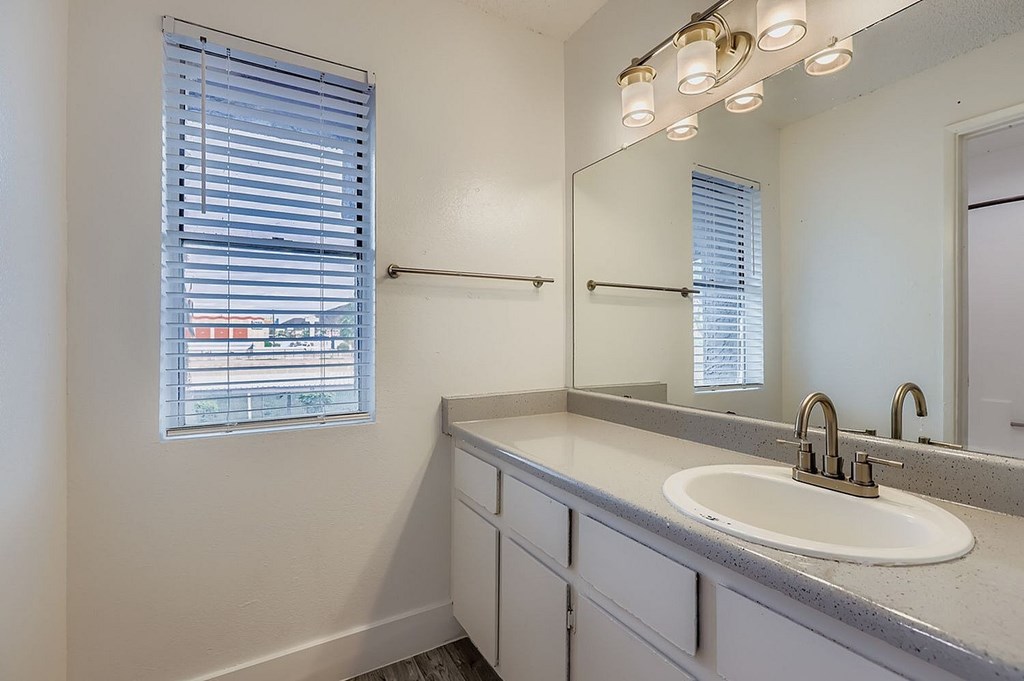 A row of washing machines are lined up in a laundry room.