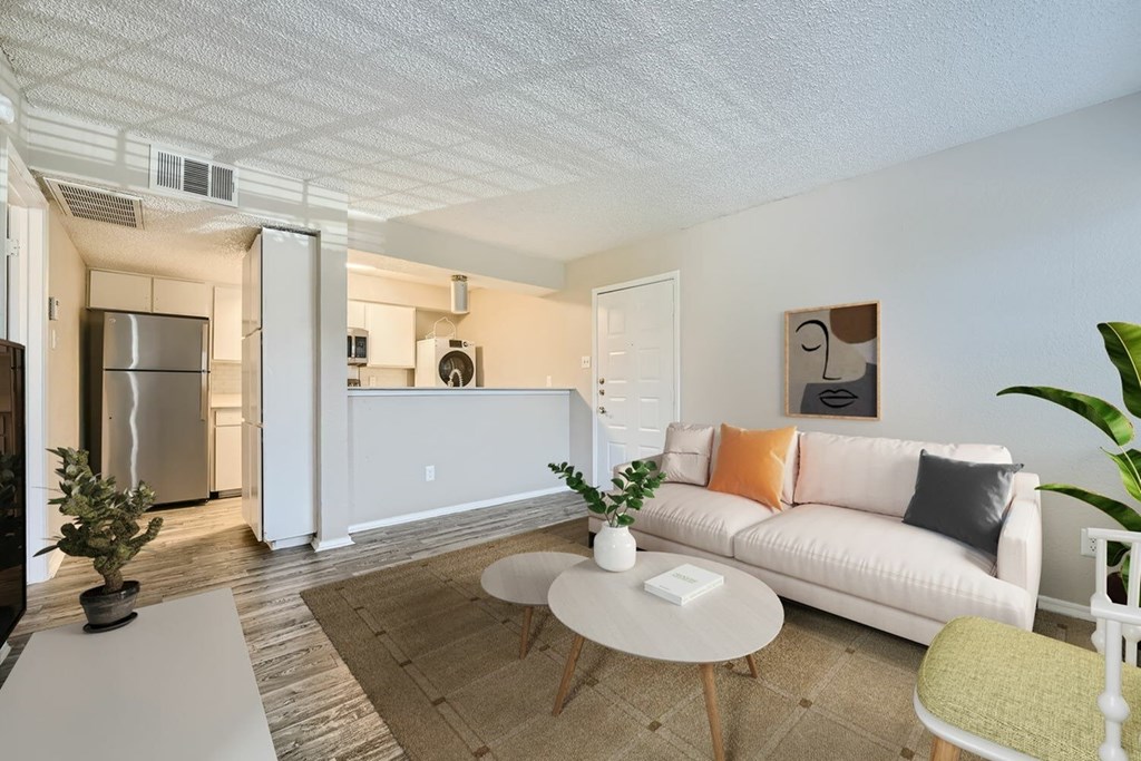 A living room with a white couch and a coffee table.