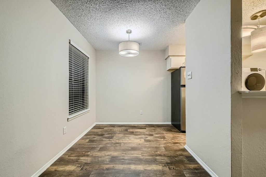A room with a wooden floor and a ceiling light.