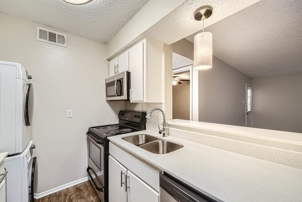 A kitchen with white appliances and a white counter top.