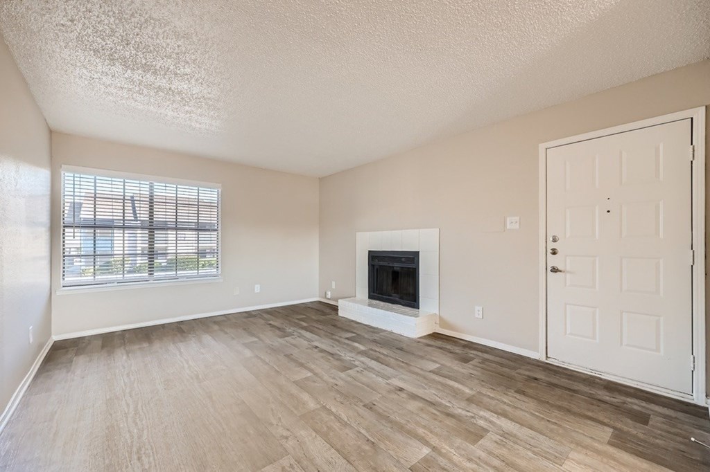 A room with a fireplace and a door.