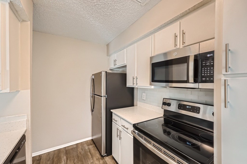 A kitchen with a black fridge and stove.