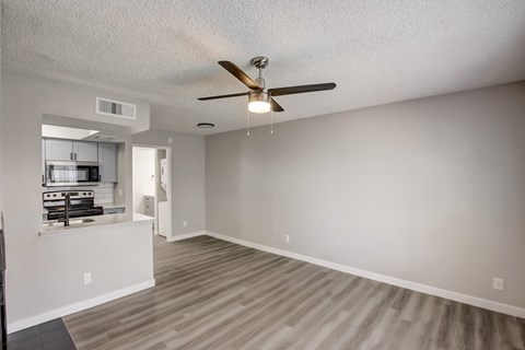 A room with a ceiling fan and light fixture.