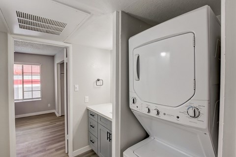 A white oven in a kitchen with a window.