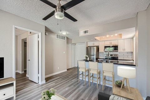 A modern kitchen with a dining table and chairs.