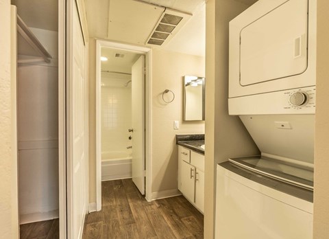 A small kitchen with a refrigerator, oven, and sink.