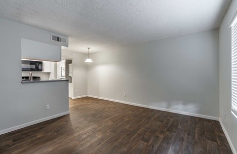 A room with wooden floors and white walls.