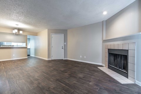 A living room with a fireplace and hardwood floors.