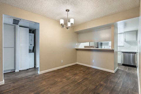 A kitchen area with a refrigerator and a dishwasher.
