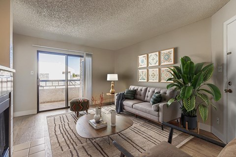 A room with wooden flooring and a white door.