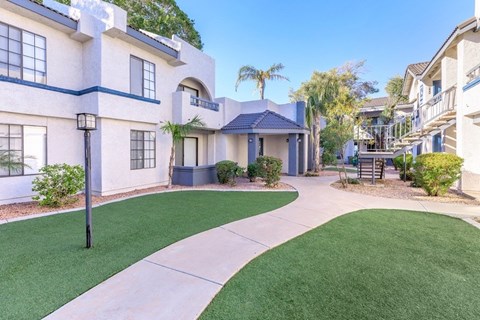 A white building with a blue trim and a black lamp post.