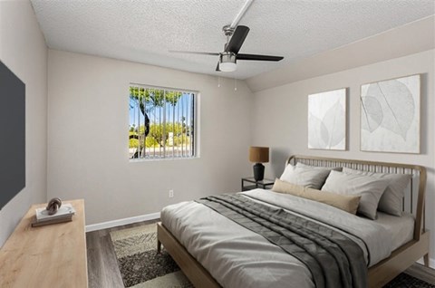 A bedroom with a bed, nightstand, and window.