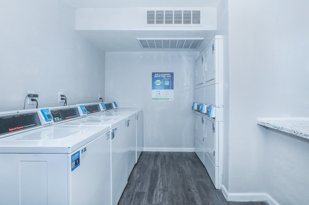 A laundry room with washers and dryers.