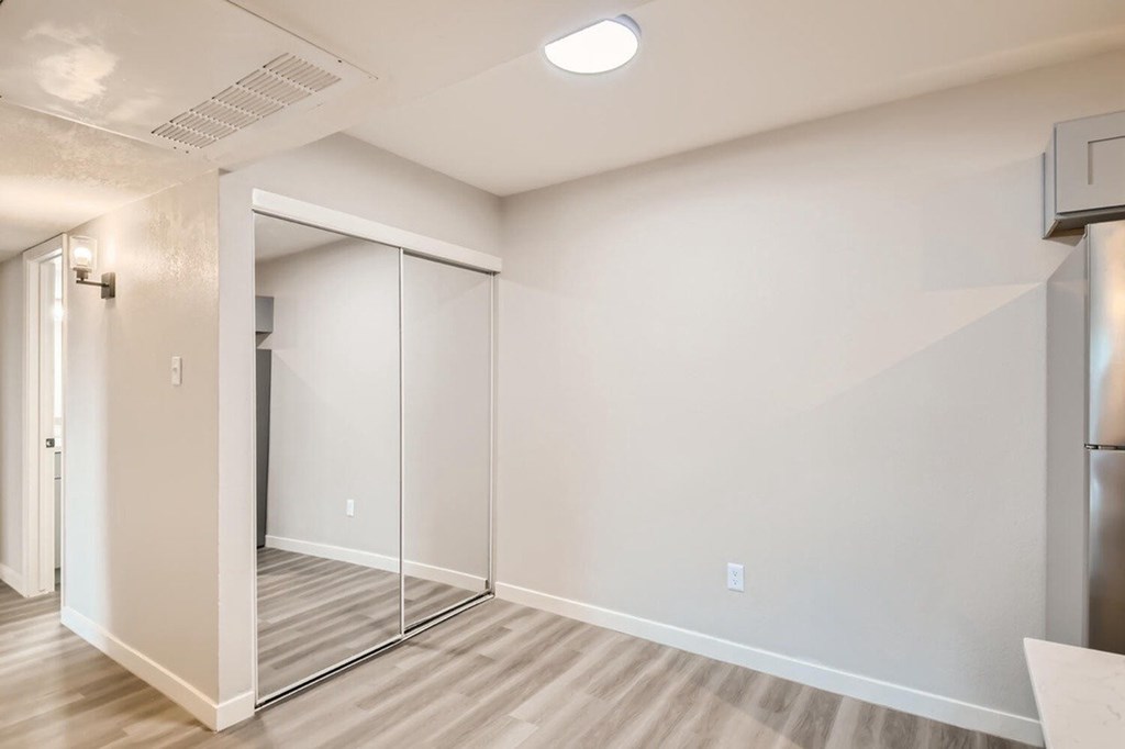 A room with a white wall and a sliding door.