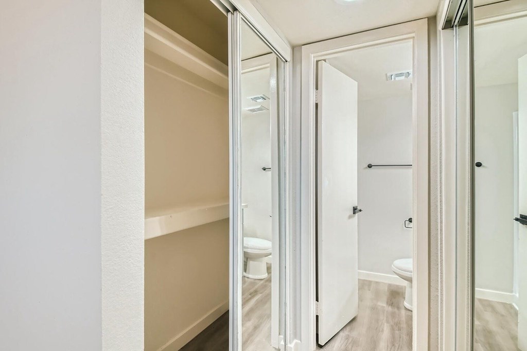 A white bathroom with a toilet and sink.