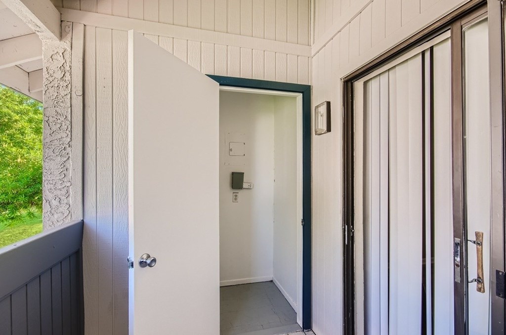 A white door is open to a hallway.
