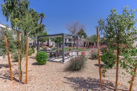 A garden with a pavilion and trees.