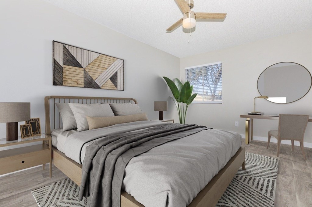 A bedroom with a large bed and a ceiling fan.