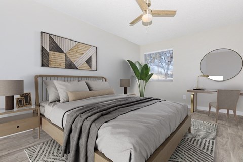 A bedroom with a large bed and a ceiling fan.