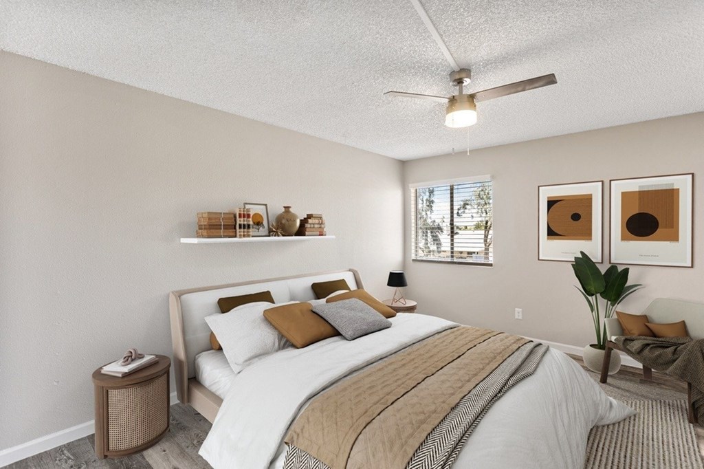 A bedroom with a bed, pillows, a ceiling fan, and a window.