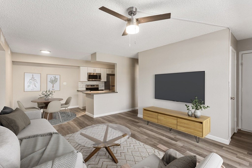 A living room with a grey couch and a wooden coffee table.