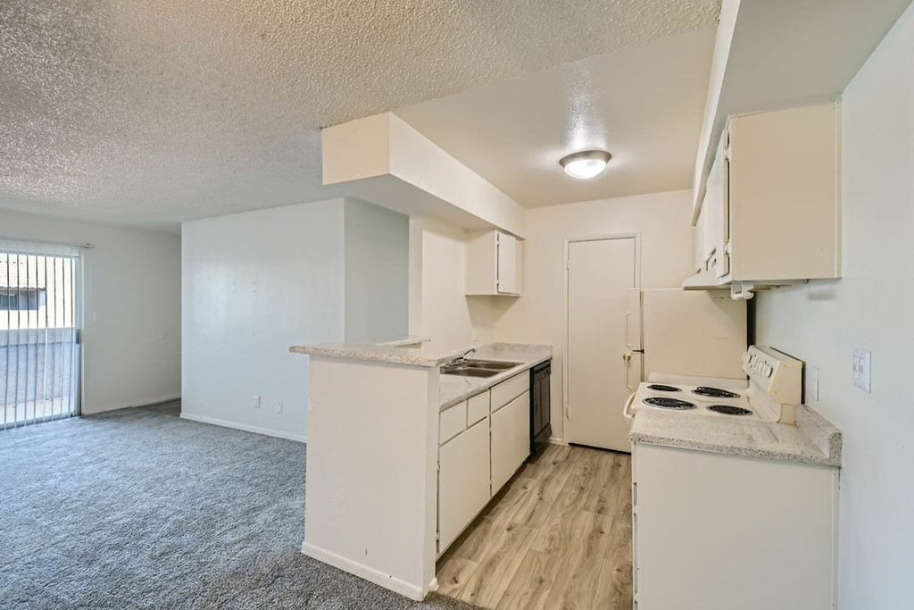 A kitchen area with a stove, oven, and cabinets.