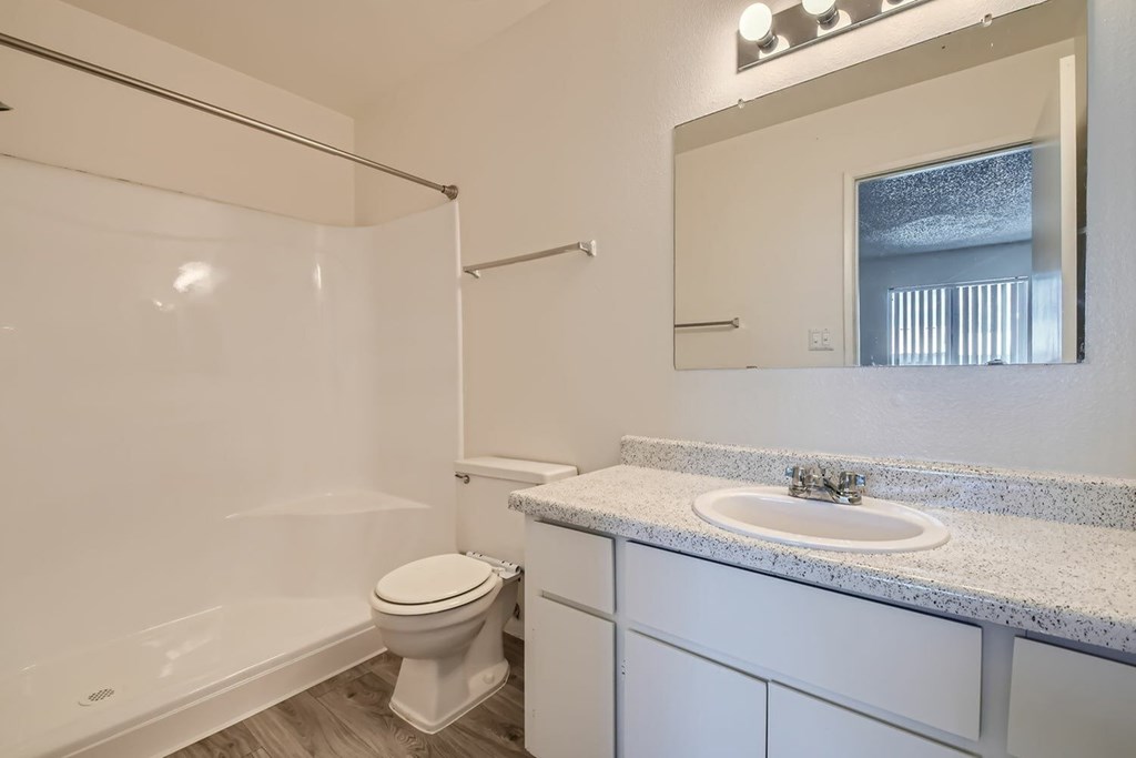 A white bathroom with a toilet, sink, and bathtub.