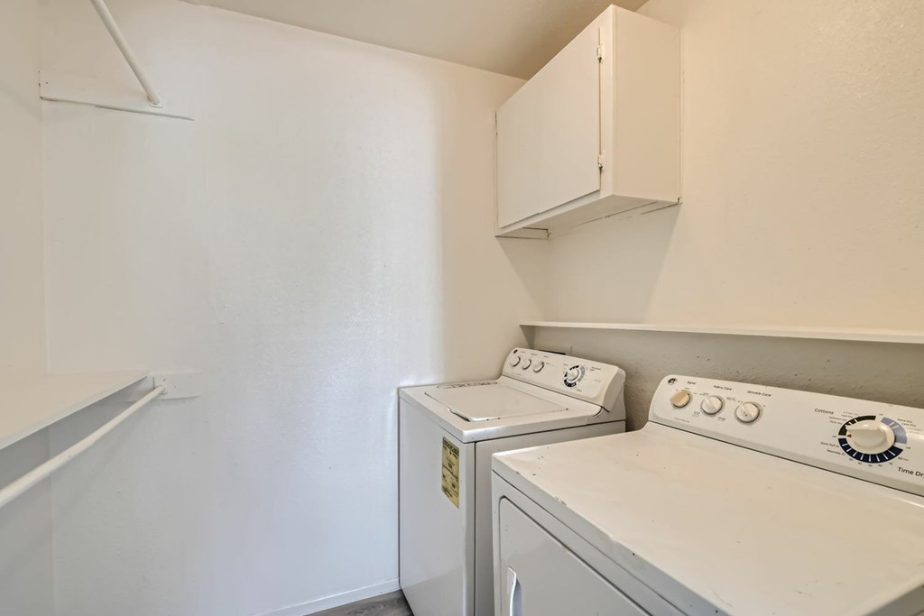 A small laundry room with a washer and dryer.
