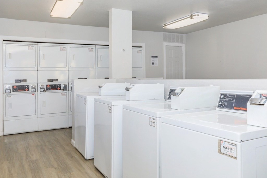 A laundry room with washers and dryers.