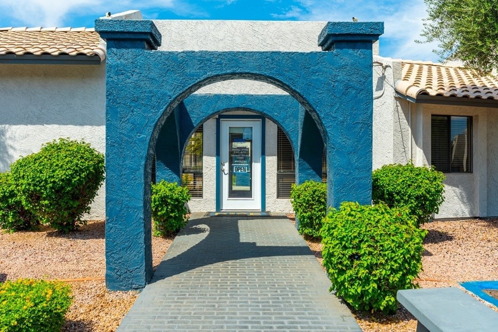 A blue archway leads to a white door.