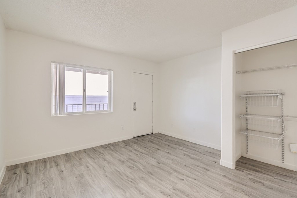 Empty room with a window and a door.