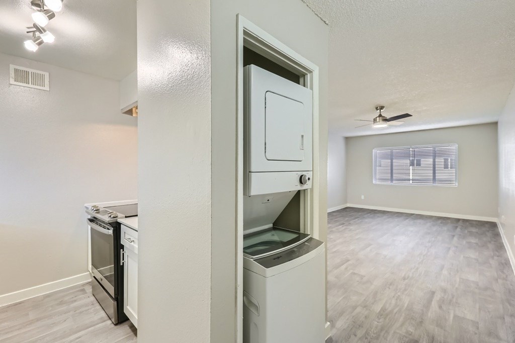 A kitchen with a refrigerator and oven built into the wall.